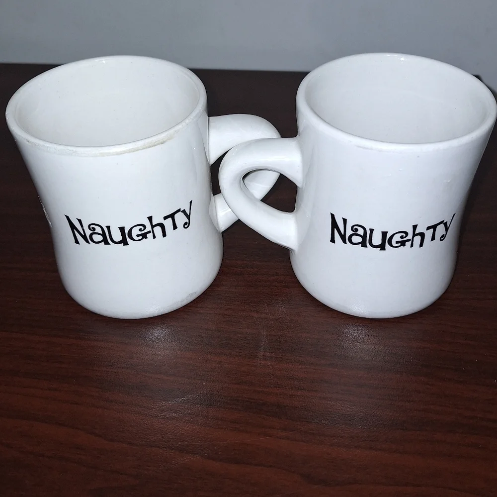 A pair of Naughty and Nice coffee mugs. Dishwasher and microwave safe.